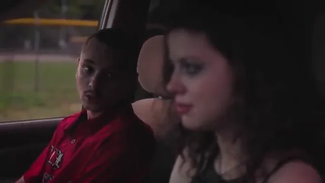 Two young people inside a car, seen in a scene from the Savage Youth trailer